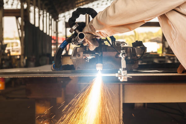 Stanz- und Umformmechaniker tragen Schutzkleidung bei der Arbeit Stanz- und Umformmechaniker tragen Schutzkleidung bei der Arbeit