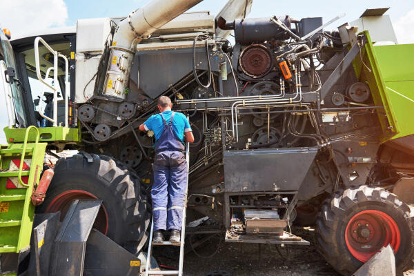 Land- und Baumaschinenmechatroniker repariert Motor