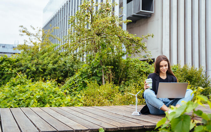 Nachhaltige Berufe – Frau mit Laptop und Windrad Nachhaltige Berufe – Frau mit Laptop und Windrad
